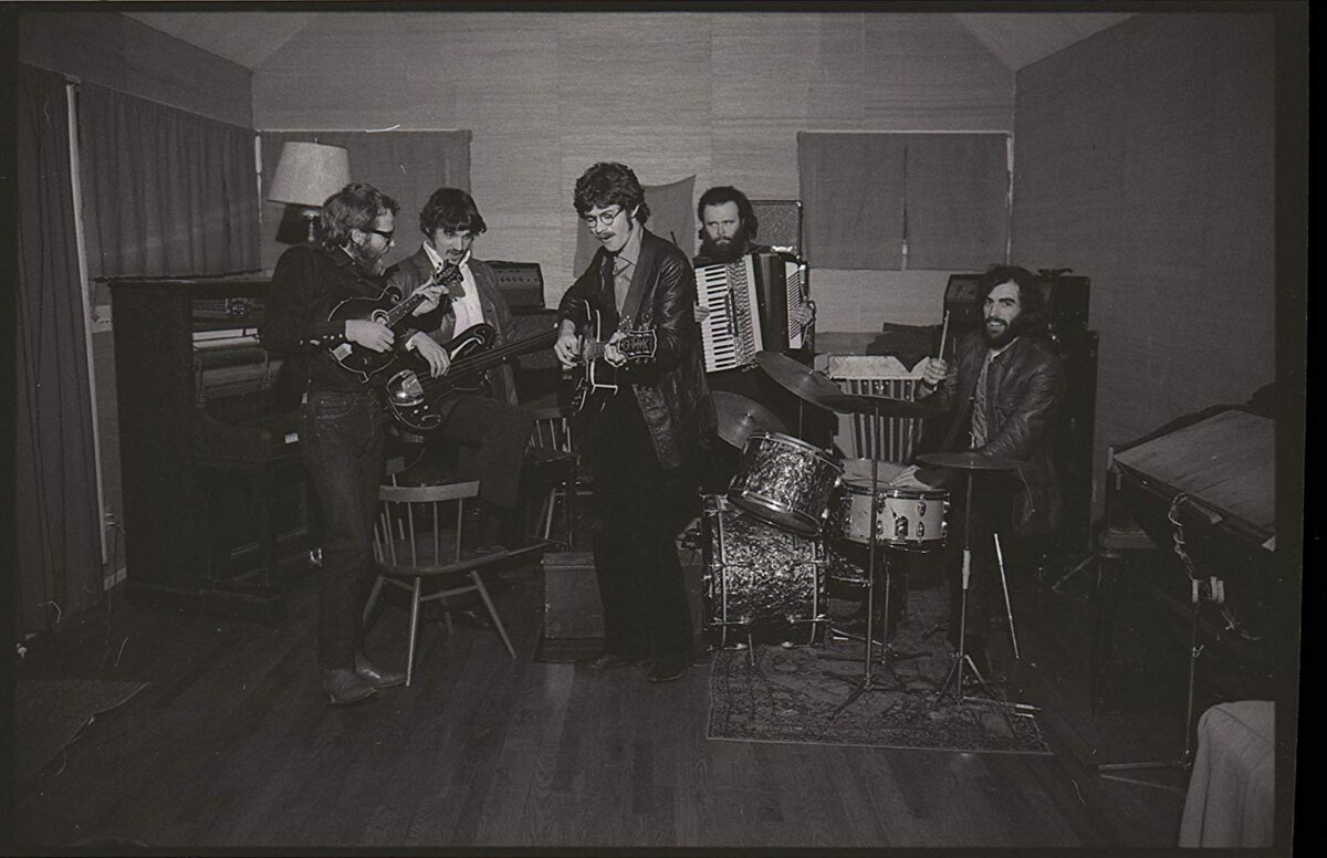 Five men playing instruments in a basement in Once Were Brothers: Robbie Robertson and The Band