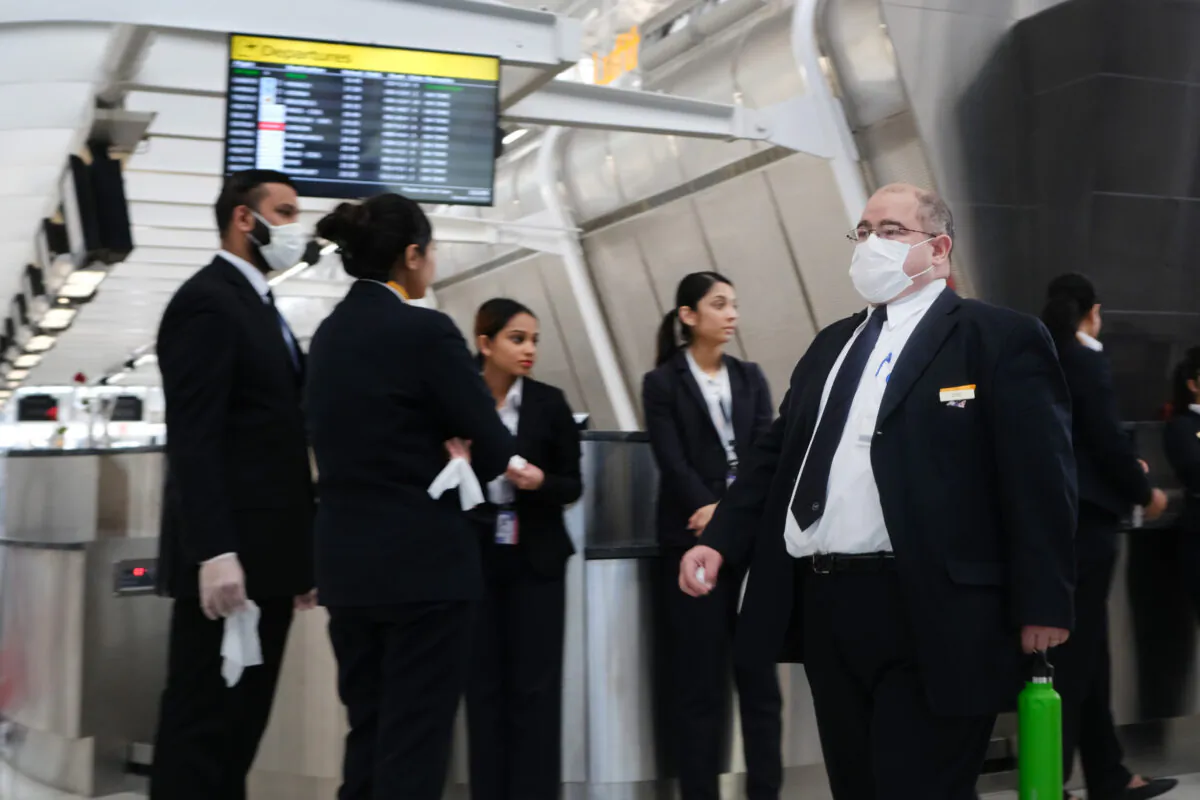 At the terminal that serves planes bound for China, airport employees wear medical masks at John F. Kennedy Airport (JFK) out of concern over the Novel Coronavirus in New York City on Jan. 31, 2020. (Spencer Platt/Getty Images)