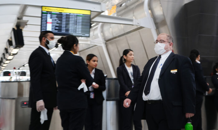 At the terminal that serves planes bound for China, airport employees wear medical masks at John F. Kennedy Airport (JFK) out of concern over the Novel Coronavirus in New York City on Jan. 31, 2020. (Spencer Platt/Getty Images)