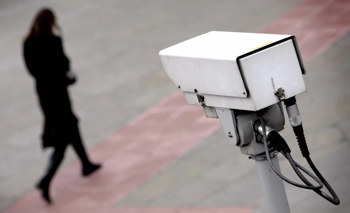 File photo of a security camera observing a woman. (Leon Neal/AFP via Getty Images)