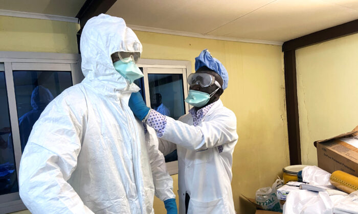 A medical staff wears protective gear at a new section specialized in receiving any person who may have been infected with coronavirus at The Quinquinie Hospital in Douala, Cameroon, on Feb. 17, 2020. (Josiane Kouagheu/Reuters)