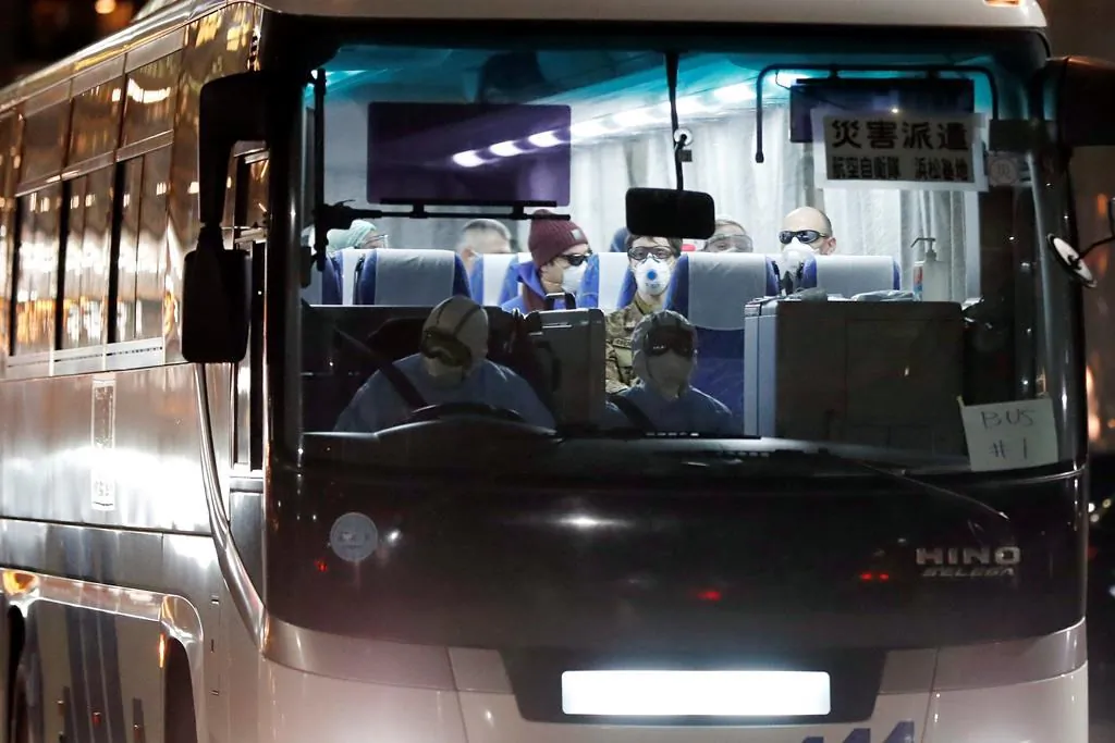 A bus carrying the passengers from the quarantined Diamond Princess cruise ship leaves a port in Yokohama, near Tokyo, on Feb. 21, 2020. (Eugene Hoshiko/AP Photo)