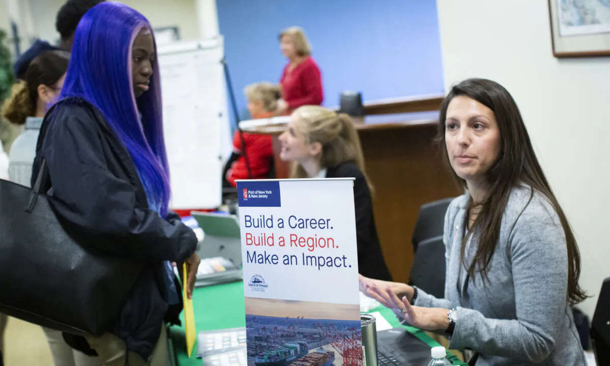 A woman offers information to attendees during a Port Authority of New York and New Jersey job fair at the Union County College in Elizabeth, N.J., on Nov. 8, 2019. (Kena Betancur/Getty Images)