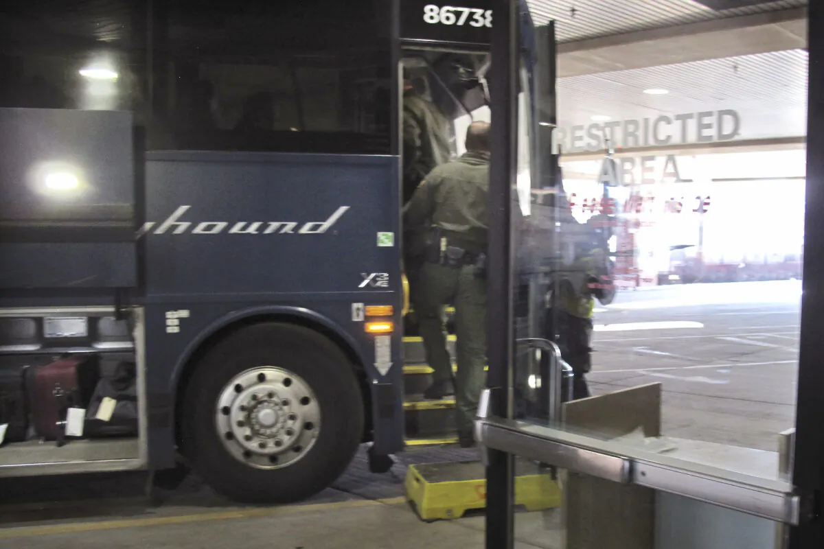 Agents for Customs and Border Protection board a Greyhound bus headed for Portland, Ore., at the Spokane Intermodal Center, a terminal for buses and Amtrak, in Spokane, Wash., on Feb.13, 2020. (Nicholas K. Geranios/AP/File)
