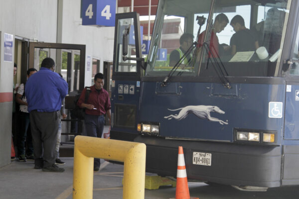 An asylum seeker from Guatemala boards a Greyhound bus in El Paso,
