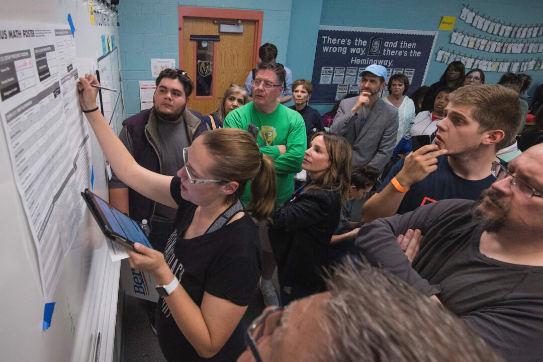 Voters watch as a volunteer counts votes during the Nevada caucuses to nominate a Democratic presidential candidate at the caucus polling station inside the Coronado High School in Las Vegas on Feb. 22, 2020. (MARK RALSTON/AFP via Getty Images)