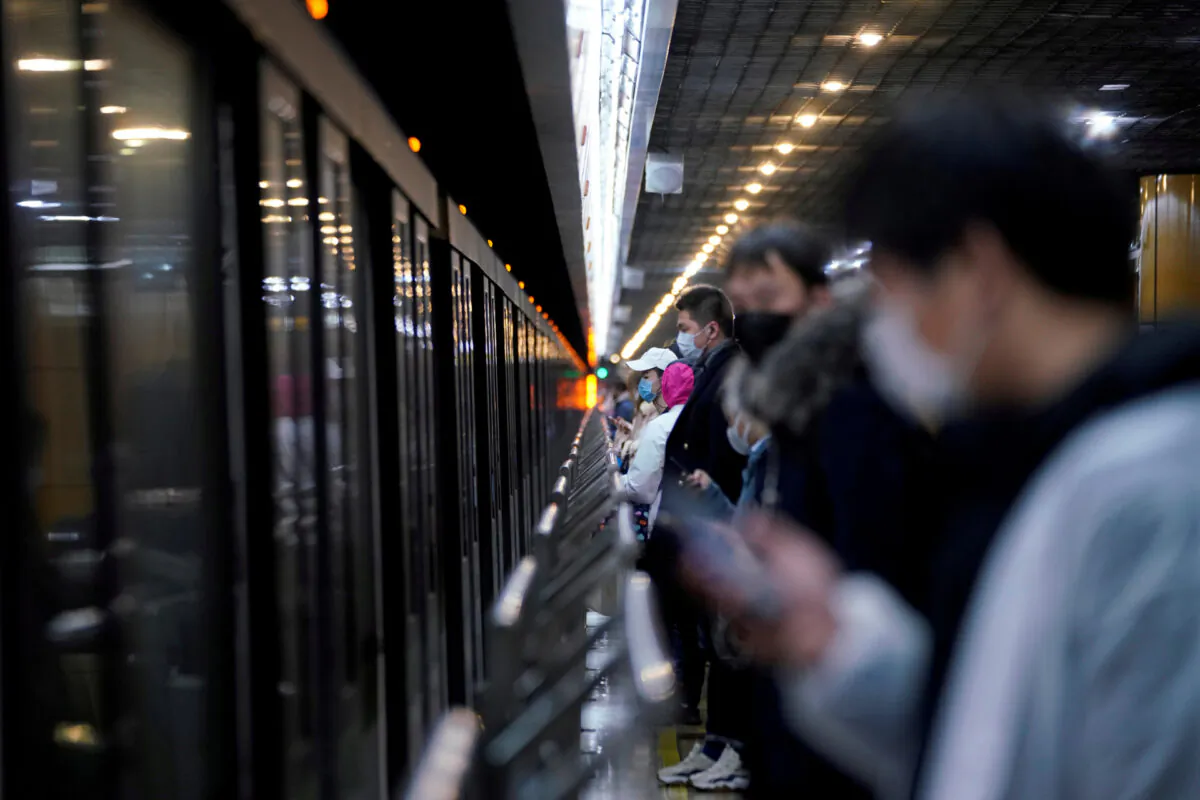 People wearing face masks are seen at a subway station in the morning after the extended Lunar New Year holiday caused by the novel coronavirus outbreak, in Shanghai, China on Feb. 10, 2020. (Aly Song/Reuters)