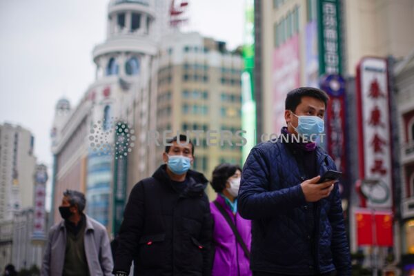 People wear masks at a main shopping area, in downtown Shanghai