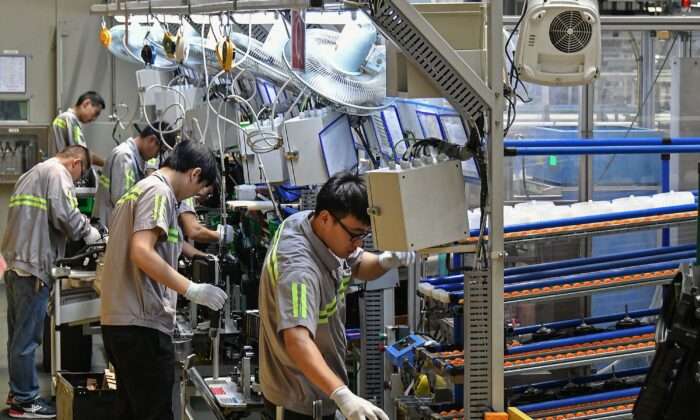 Employees work on an automobile air conditioning production line at a factory in Yantai in China's eastern Shandong Province on May 15, 2019. (STR/AFP via Getty Images)