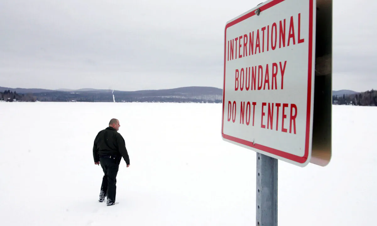 U.S. Border Patrol Agent Andrew Mayer walks onto a frozen lake during a patrol on the lake that is split between Canadian territory to the right and the U.S., near Norton, Vermont, on March 22, 2006.  Joe Raedle/Getty Images