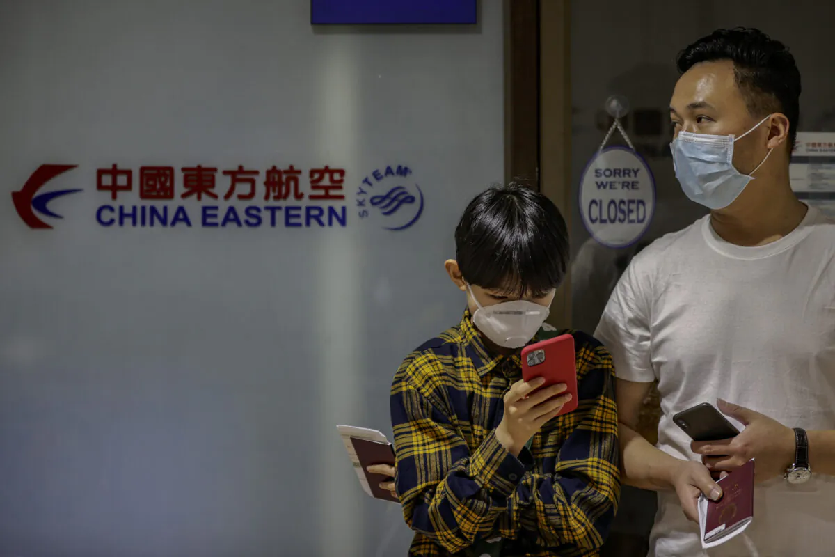 Chinese nationals, whose flight was cancelled after the Philippine government imposed travel restrictions to and from China amid the outbreak of the novel coronavirus, wait outside the closed ticketing office of China Eastern Airlines at the Ninoy Aquino International Airport in Manila, Philippines, on Feb. 3, 2020. (Ezra Acayan/Getty Images)