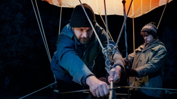 men cutting hot air balloon ties