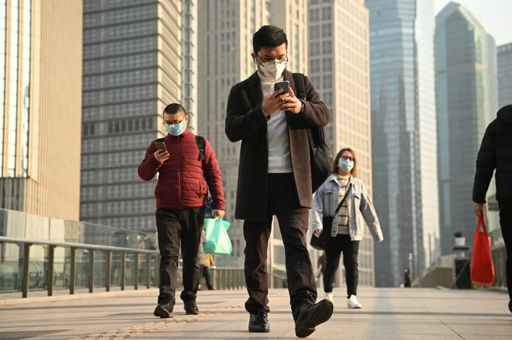 People wearing protective face masks on an overpass in Shanghai on Feb. 24, 2020. (Noel Celis/AFP via Getty Images)