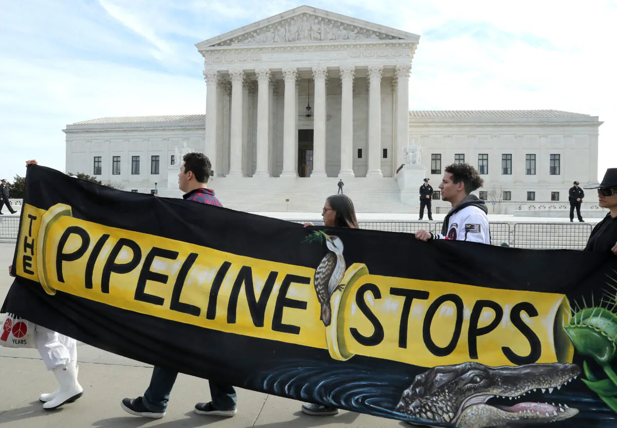 Climate activist groups protest in front of the U.S. Supreme Court as oral arguments are heard in U.S. Forest Service and Atlantic Coast Pipeline, LLC v. Cowpasture River Assn., in Washington on Feb. 24, 2020. (Mark Wilson/Getty Images)