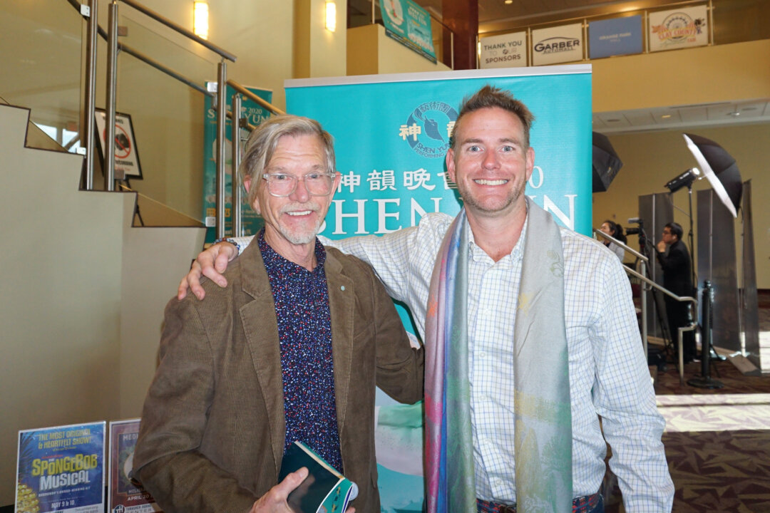 Watercolor painter Tom Barnes (L) and his son attended Shen Yun Performing Arts at the Thrasher-Horne Center in Jacksonville, Florida, on Feb. 23, 2020. (Sally Sun/The Epoch Times)