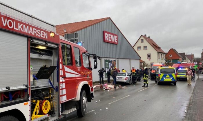 People react at the scene after a car ploughed into a carnival parade injuring several people in Volkmarsen, Germany, on Feb. 24, 2020. (Elmar Schulten/Waldeckische Landeszeitung via Reuters)
