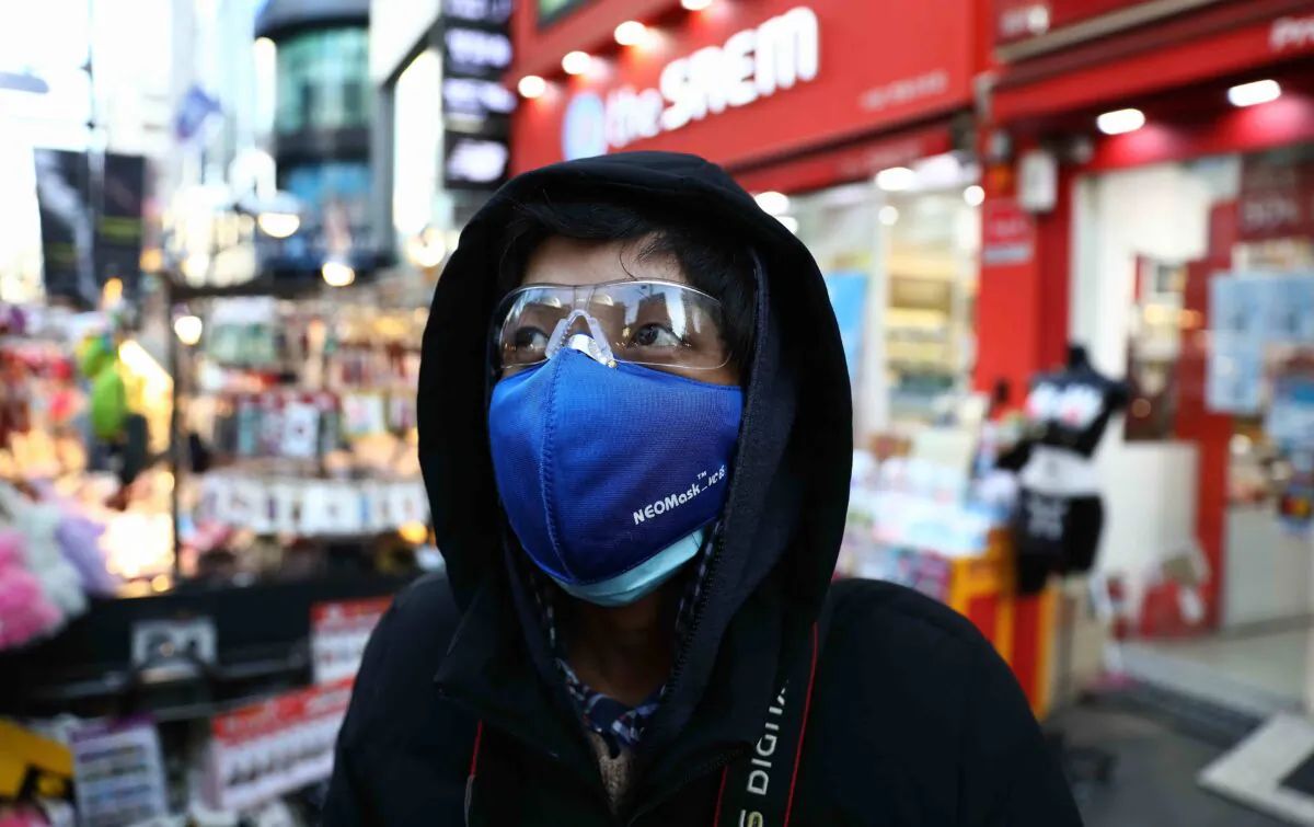 A man wearing a mask to prevent the coronavirus walks in the Myungdong shopping district in Seoul on Feb. 23, 2020. (Chung Sung-Jun/Getty Images)