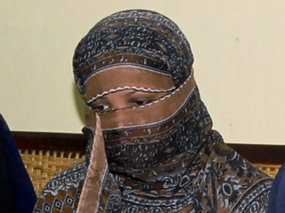 Asia Bibi, a Pakistani Christian woman, listens to officials at a prison in Sheikhupura near Lahore, Pakistan, on Nov. 20, 2010. (AP Photo/File)