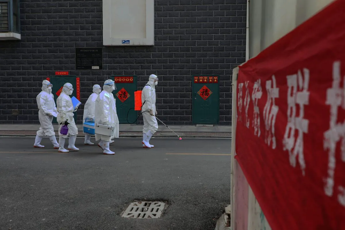 A group of laboratory technicians making their way during an epidemiological investigation in Linyi city, Shandong Province, China on Feb. 10, 2020. (STR/AFP via Getty Images)