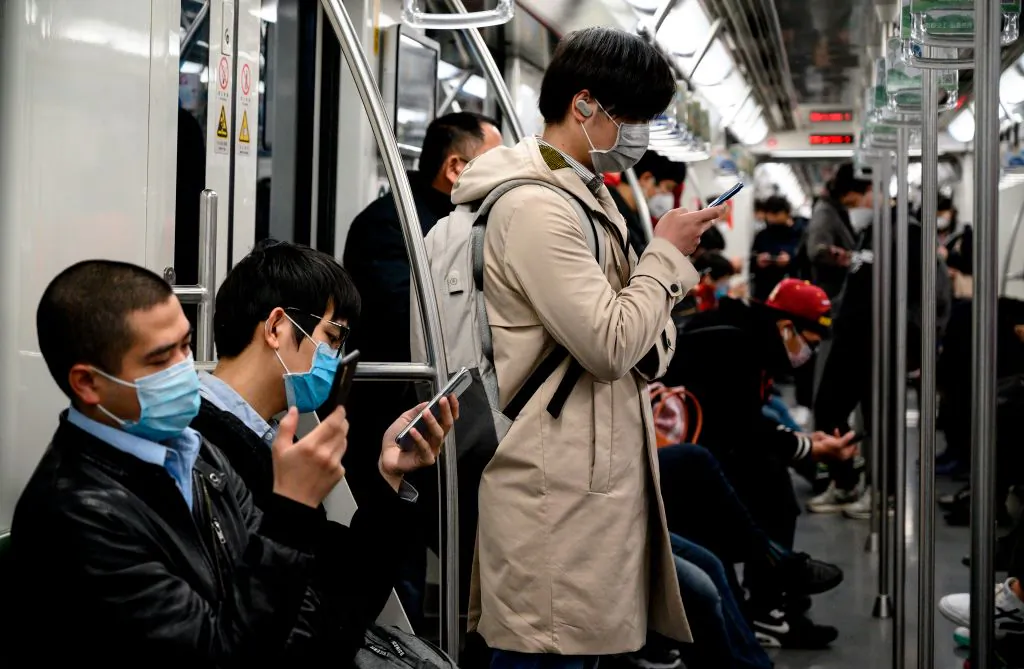 Passengers wearing protective face masks travel on the subway in Shanghai on Feb. 25, 2020. (Noel Celis/AFP via Getty Images)