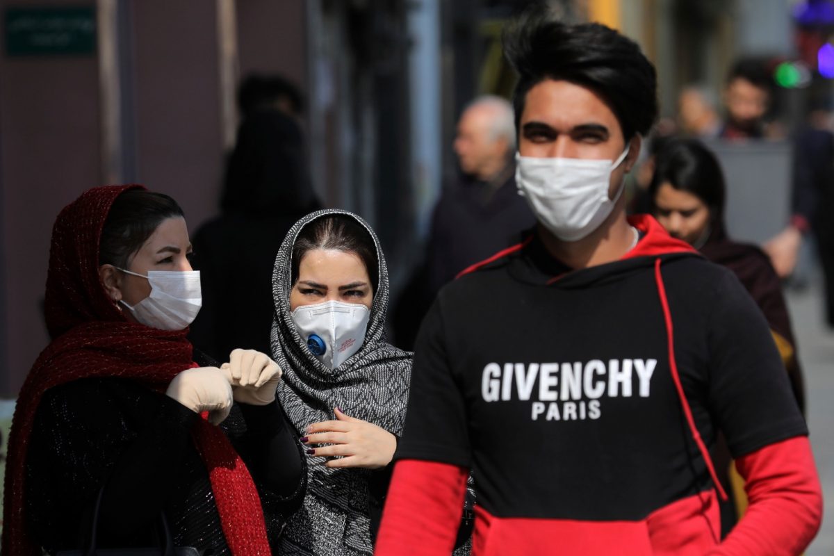 Pedestrians wear masks to help guard against the Coronavirus