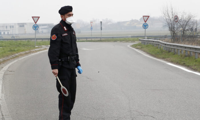 Carabinieri (Italian paramilitary police) officer checks enter or leave the cordoned area in Casalpusterlengo, Italy, on Feb. 25, 2020.(Antonio Calanni/AP Photo)