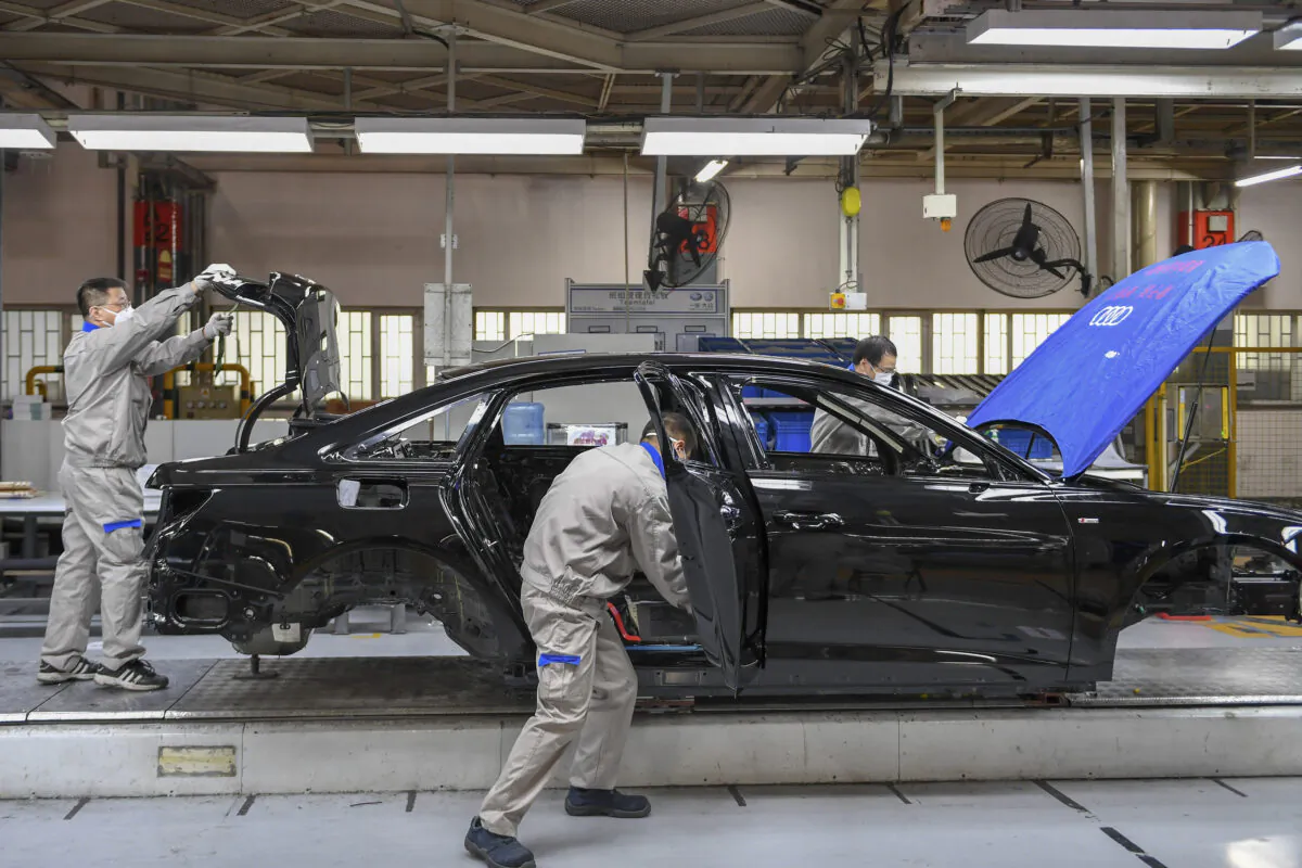 Workers assemble Audi A6 L cars at a workshop of FAW-Volkswagen Automobile Co., Ltd. in Changchun, northeast China's Jilin Province on Feb. 17, 2020. (Zhang Nan/Xinhua via AP)