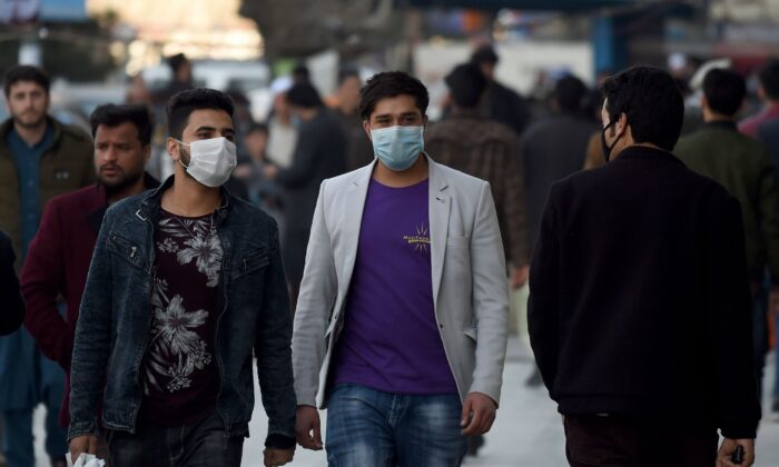 Men wearing protectives facemasks walk at the Shahr-i-Naw area in Kabul, Afghanistan, on Feb. 5, 2020. (Wakil Kohsar/AFP via Getty Images)