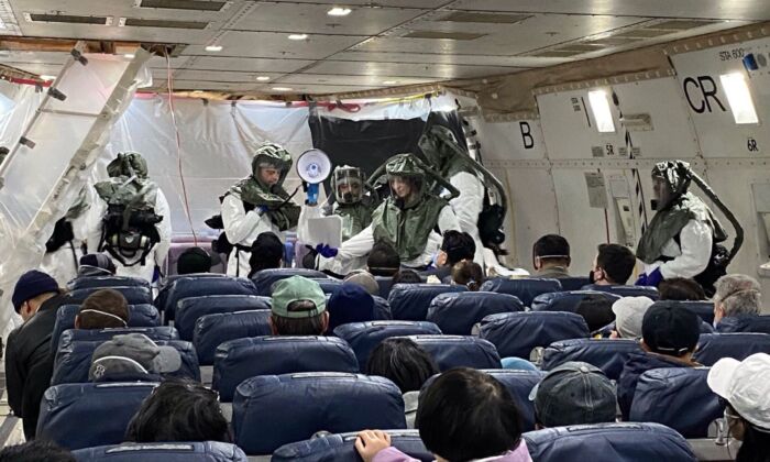 David and his peers on the evacuation plane waiting to go back to the United States at Wuhan Tianhe Airport in Wuhan, China, on Feb. 5, 2020. (Provided to The Epoch Times by David)