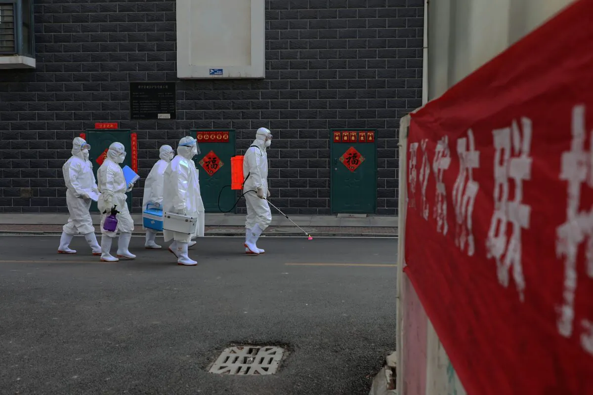 Laboratory technicians making their way during an epidemiological investigation in Linyi in China's eastern Shandong province on Feb. 10, 2020. (STR/AFP via Getty Images)