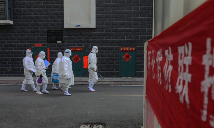 Laboratory technicians making their way during an epidemiological investigation in Linyi in China's eastern Shandong province on February 10, 2020. (STR/AFP via Getty Images)