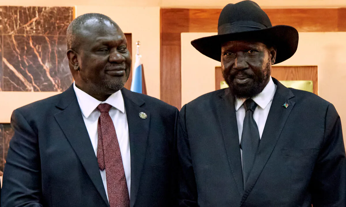 South Sudanese President Salva Kiir (R) shakes hands with First Vice President Riek Machar as he ttends his swearing-in ceremony at the State House in Juba, South Sudan, on Feb. 22, 2020. (Alex McBride/AFP via Getty Images)