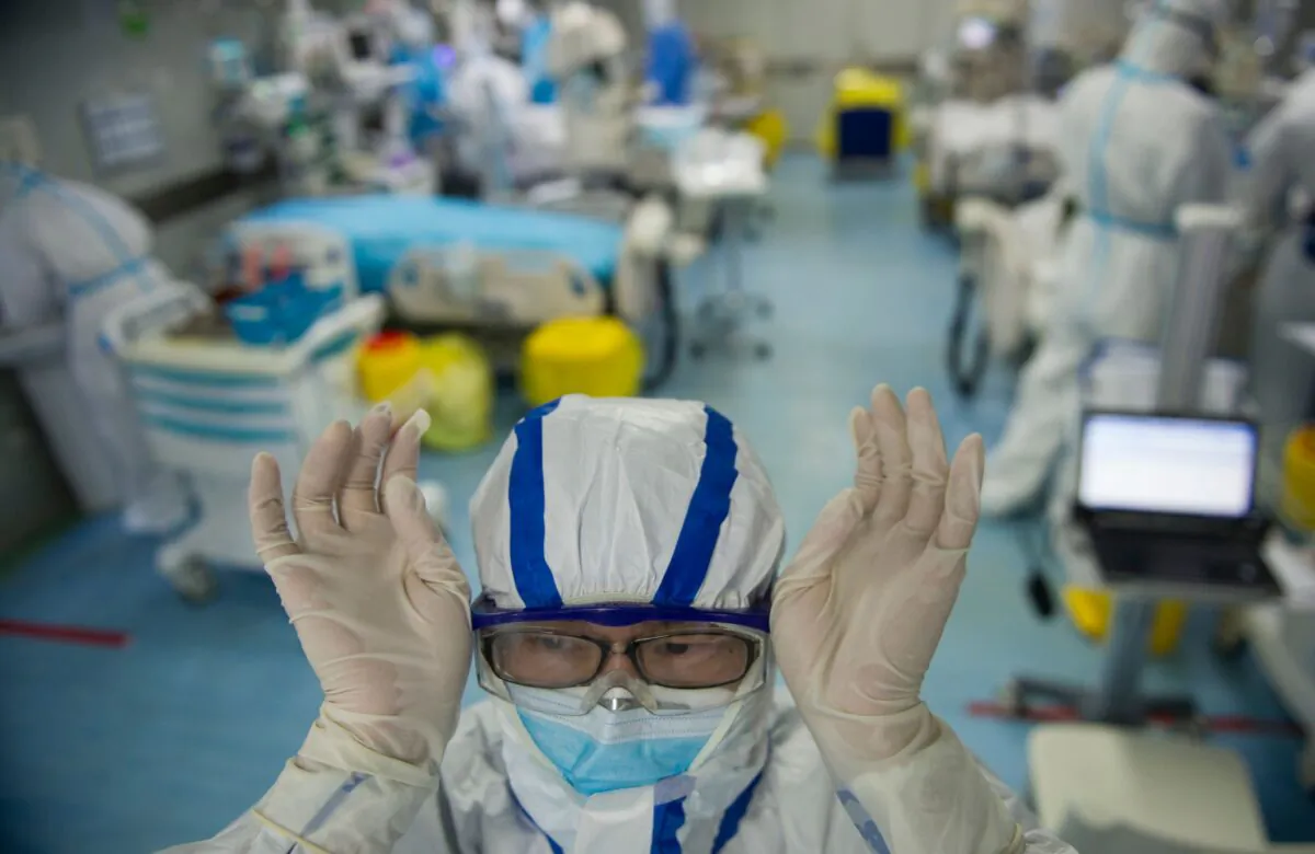 A nurse adjusts his goggles in an intensive care unit treating COVID-19 patients at a hospital in Wuhan, China, on Feb. 22, 2020. (STR/AFP via Getty Images)