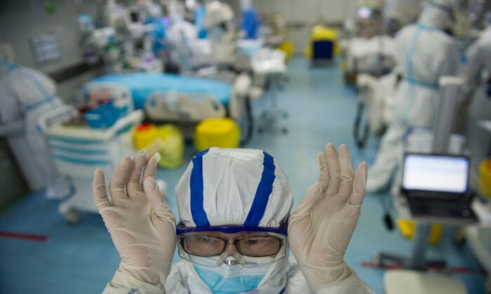 A nurse adjusts his goggles in an intensive care unit treating COVID-19 patients at a hospital in Wuhan, China, on Feb. 22, 2020. (STR/AFP via Getty Images)