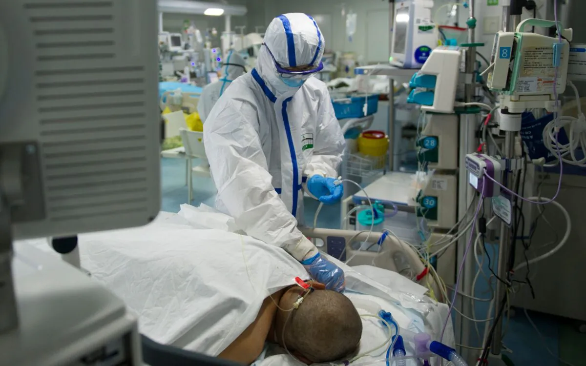 A nurse checking a patient in an intensive care unit treating COVID-19 coronavirus patients at a hospital in Wuhan, in China's central Hubei Province, on Feb. 22, 2020. (STR/AFP via Getty Images)