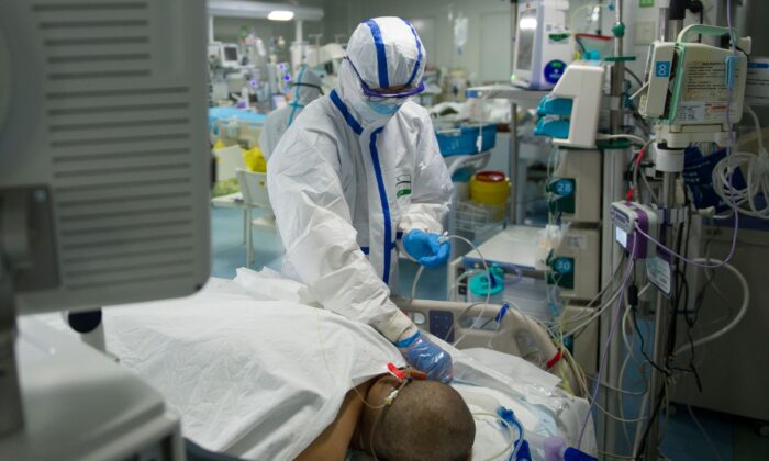 A nurse checking a patient in an intensive care unit treating COVID-19 coronavirus patients at a hospital in Wuhan, in China's central Hubei Province, on Feb. 22, 2020. (STR/AFP via Getty Images)