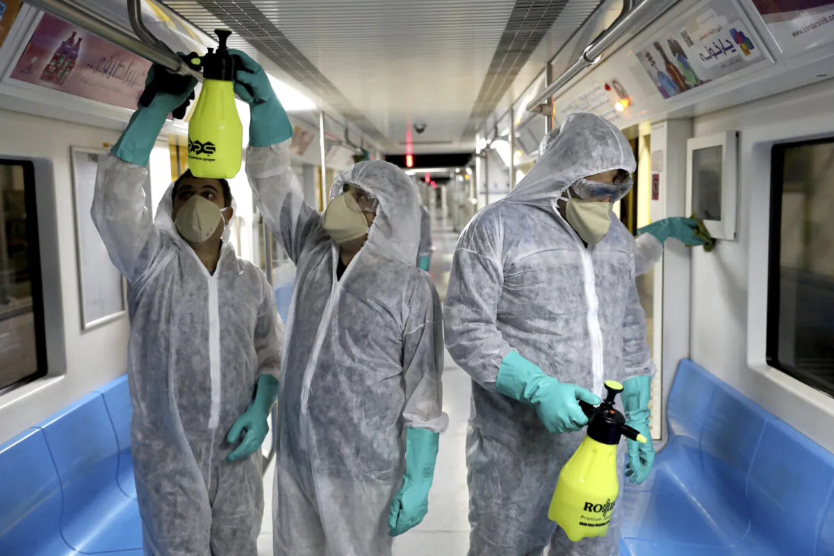 Workers disinfect subway trains against coronavirus in Tehran, Iran, in the early morning of Feb. 26, 2020. (Ebrahim Noroozi/AP Photo)