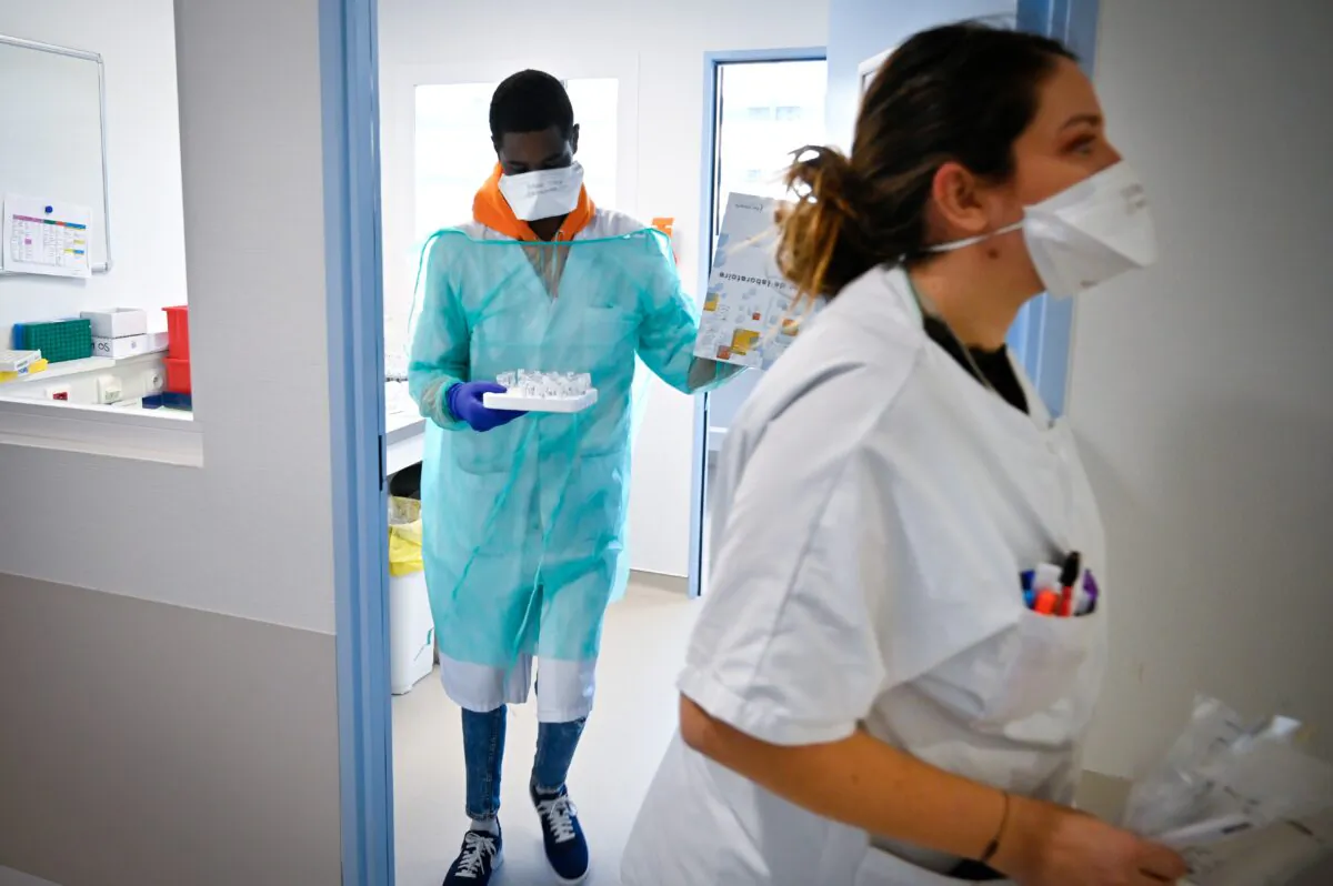 Medical staff work in the laboratory to analyze samples on the possible presence of COVID-19 in a file photo. (Gerard Julien/AFP via Getty Images)