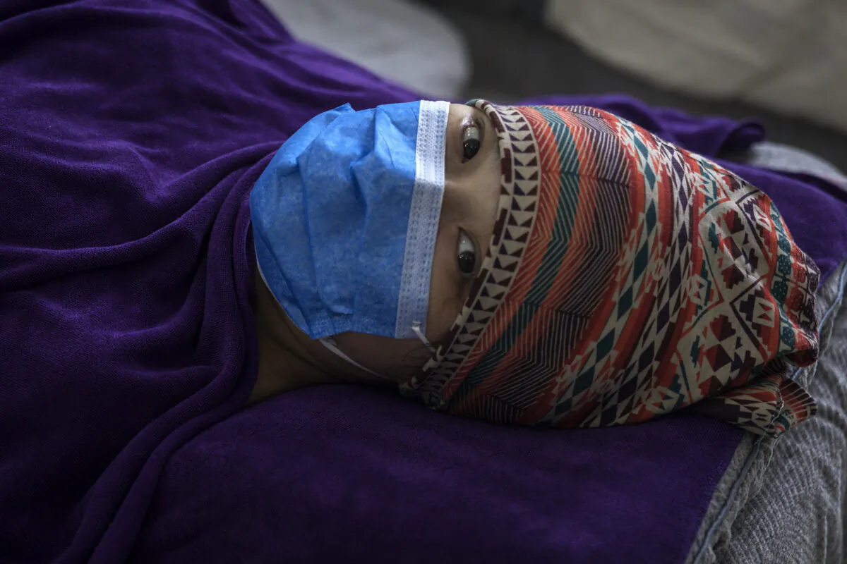 A patient is lying in a private obstetric hospital in Wuhan, China, on Feb. 24, 2020. (Getty Images)