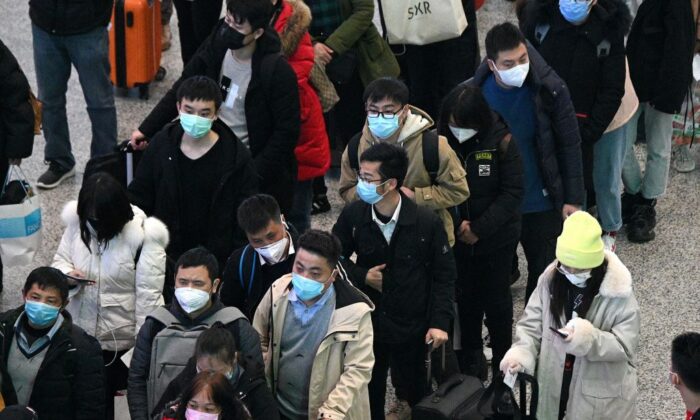 Passengers wearing protective face masks arrive at the Hongqiao railway station in Shanghai on Feb. 26, 2020. (Noel Celis/AFP via Getty Images)