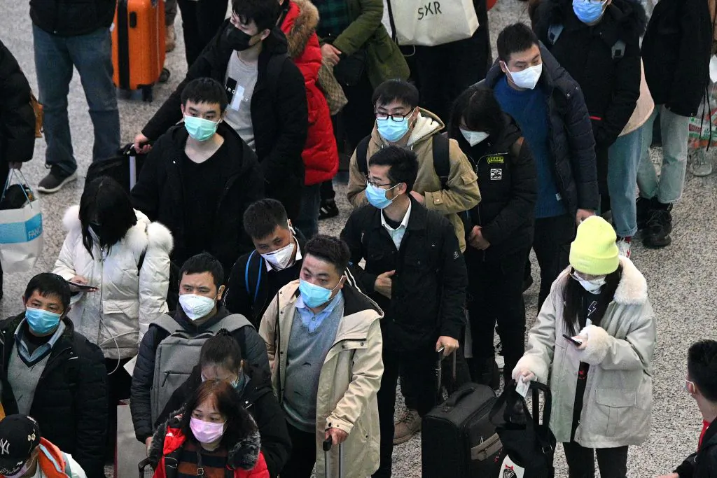 Passengers wearing protective face masks arrive at the Hongqiao railway station in Shanghai on Feb. 26, 2020. (Noel Celis/AFP via Getty Images)