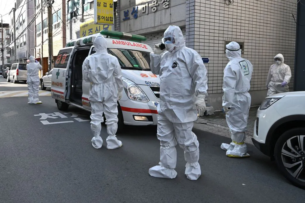 South Korean medical workers wearing protective gear visit a residence of people with suspected symptoms of the novel coronavirus to take samples, near the Daegu branch of the Shincheonji Church in South Korea, on Feb. 27, 2020. (Jung Yeon-je/AFP via Getty Images)