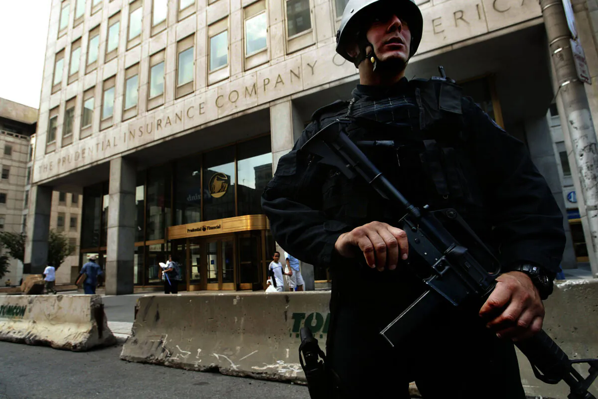 A heavily armed Newark Police officer stands guard outside the Prudential Insurance Company building in Newark, N.J., on Aug. 10, 2004. (Chris Hondros/Getty Images)