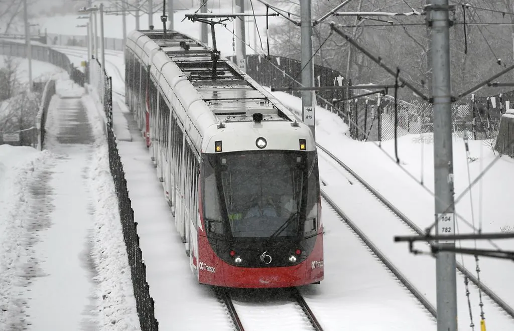 An OC Transpo LRT train heads towards Lees Station on the Confederation Line during a snowstorm in Ottawa, on Feb. 27, 2020. (Justin Tang/The Canadian Press)