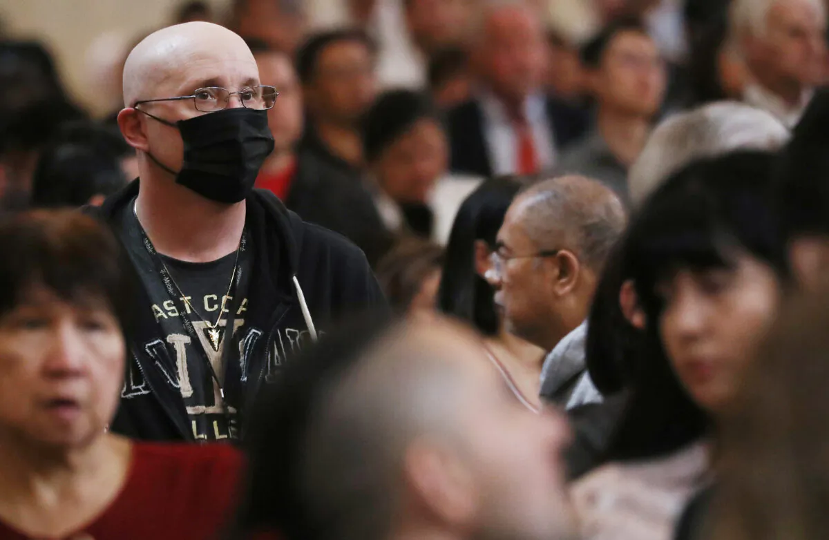 A worshipper (L) wears a face mask to protect against the coronavirus while sitting in a pew at the Cathedral of Our Lady of the Angels on Ash Wednesday on Feb. 26, 2020 in Los Angeles, Calif. (Mario Tama/Getty Images)