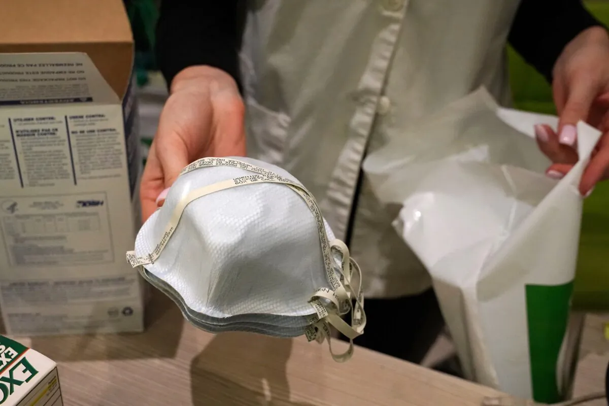 A pharmacy worker sells N95 face masks in the Manhattan borough of New York City on Feb. 27, 2020. (Carlo Allegri/Reuters)
