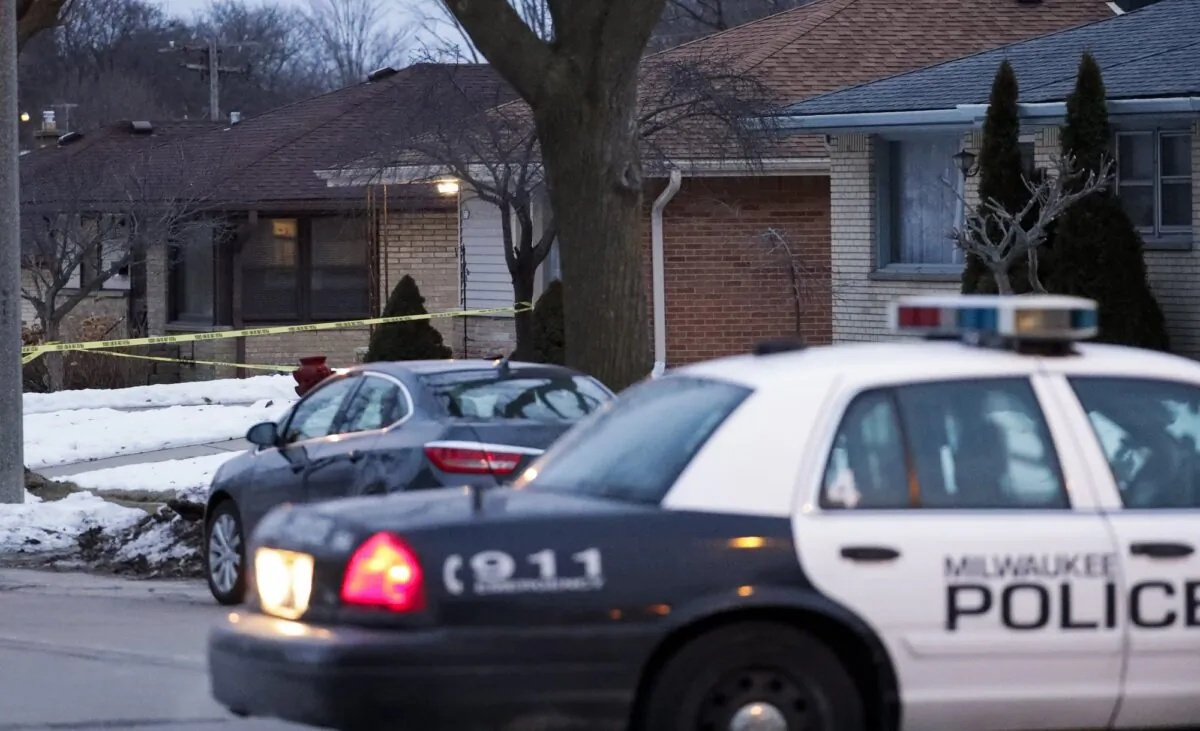 Police are seen outside of a house near Potomac and Courtland after a shooting at Molson Coors on Feb. 26, 2020, in Milwaukee. (Morry Gash/AP)
