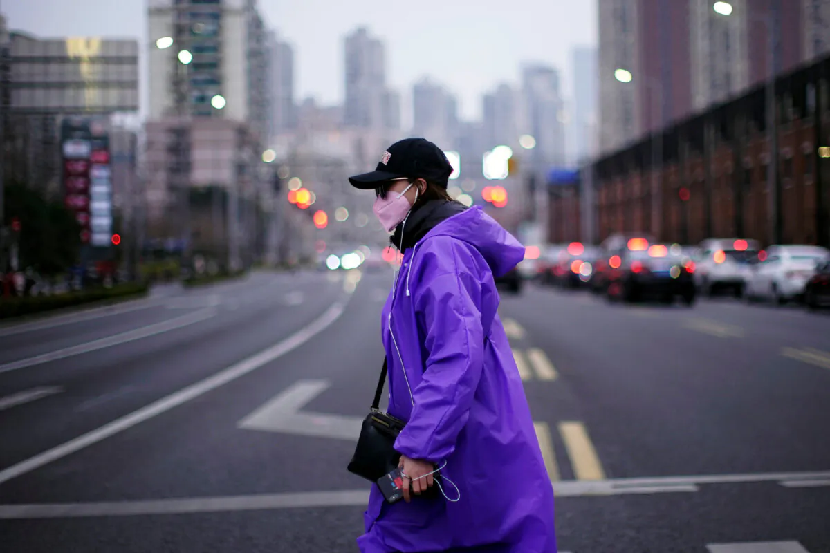 A woman wearing a face mask is seen on a street in downtown Shanghai, China, on Feb. 26, 2020. (Aly Song/Reuters)