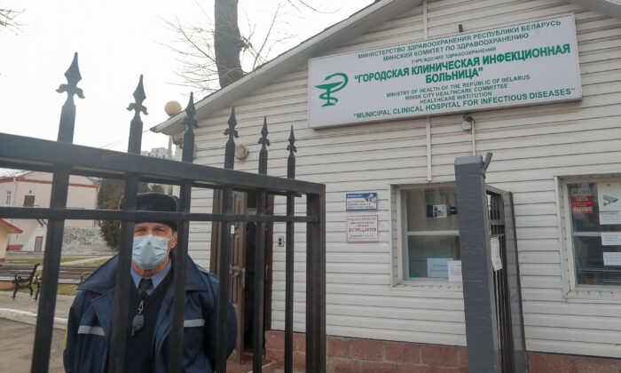 A security guard looks through a gate of a hospital for infectious diseases, after Belarus registered the first case of coronavirus infection in the country, in Minsk, Belarus on Feb. 28, 2020. (Vasily Fedosenko/Reuters)