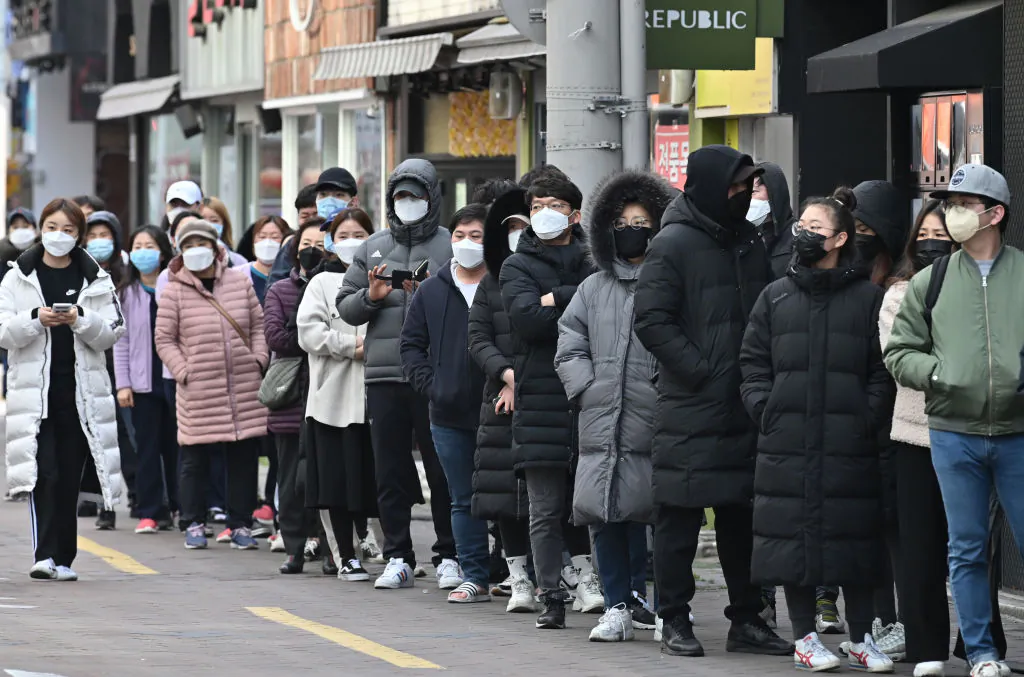 People wait in line to buy face masks from a store at the Dongseongro shopping district in Daegu, South Korea, on Feb. 27, 2020. (Jung Yeon-je/AFP via Getty Images)